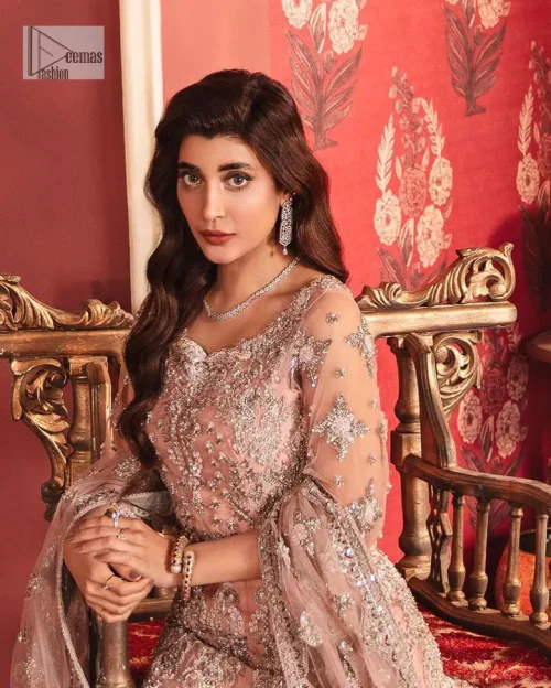 The beautiful outfit comes has an alluring peach colour and is gracefully emblazoned with embroidery. Hand-crafted details of tilla, dabka,