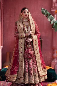 Deep shades of this reception wear just to brighten up your days. The deep red frock is intricately emblazoned with golden embellishments. Red floral designs and threads give an elegant touch to the frock Graceful details of tilla, dabka, kora, Kundan and Zardozi make this beautiful frock a perfect choice to pair with Wedding sharara. The round neckline of the following blouse intensifies the beauty. Furthermore, the full sleeves are decorated with floral patterns. The following deep red frock is coordinated with fish cut sharara having detailed embroidery. Complete this outfit with a dupatta framed with four-sided borders and floral jaal all over.