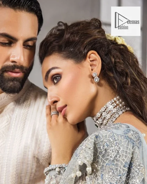 A Gray flared maxi, heavily hand embellished with floral branches and botanical motifs.