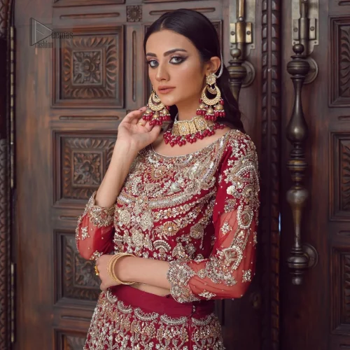 Embrace timeless allure with the Maroon Wide Flared Lehenga Blouse, an exquisite choice for your wedding celebration. This luxurious lehenga