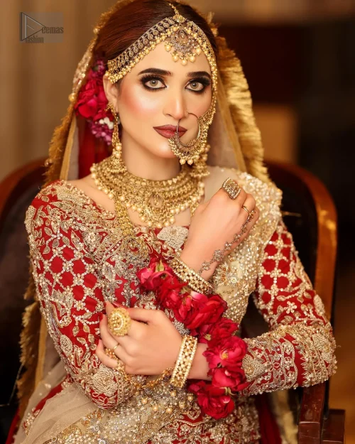 The soft Fawn dupatta adds an air of refinement. The dress is adorned with intricate golden and antique-toned embroidery, showcasing