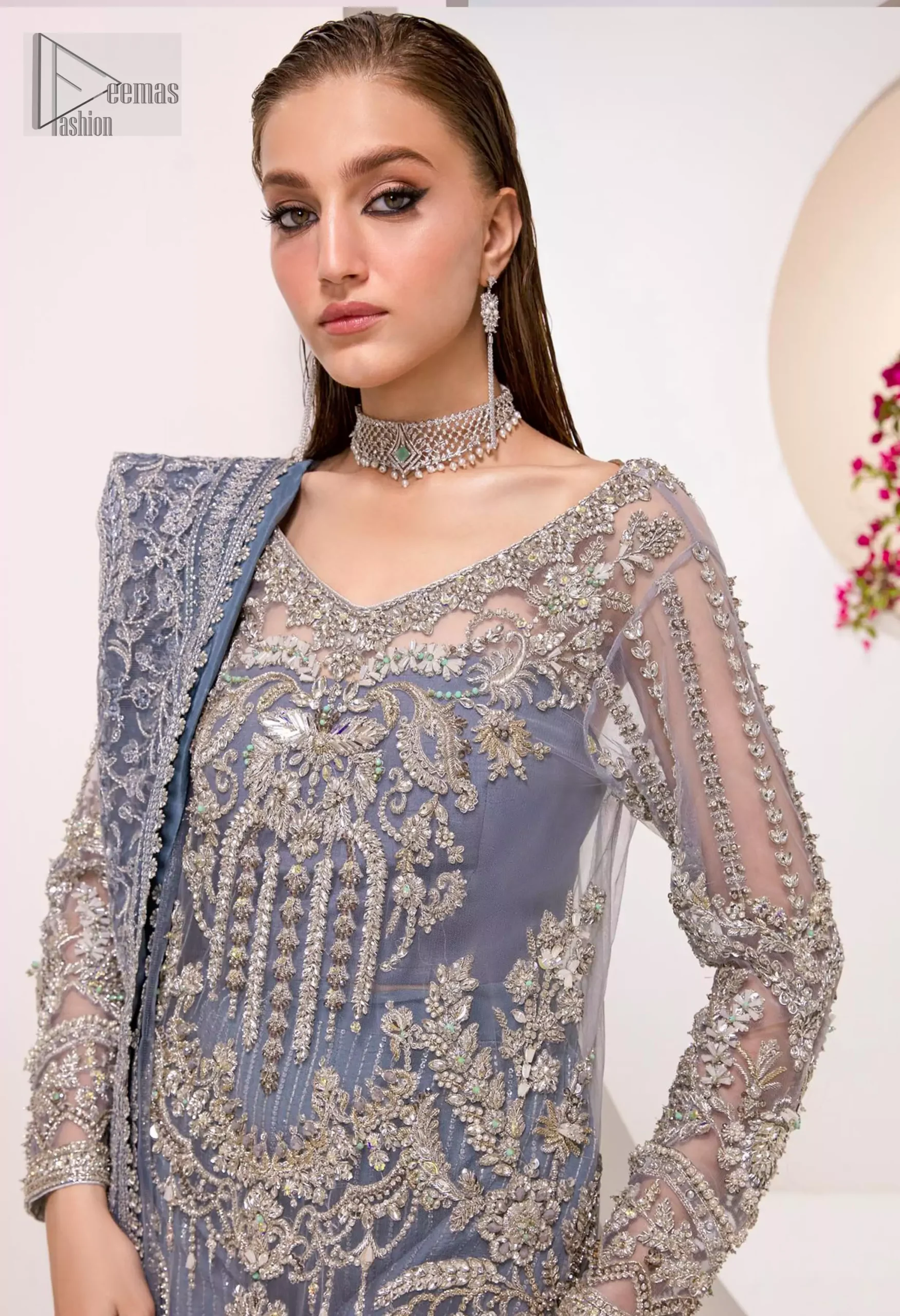 tep into your Nikah celebration with the Blue Shirt Dupatta Sharara, an ensemble that exudes grace and sophistication. The shirt, with its full sleeves and V-neckline, is adorned with delicate silver & golden embroidery.