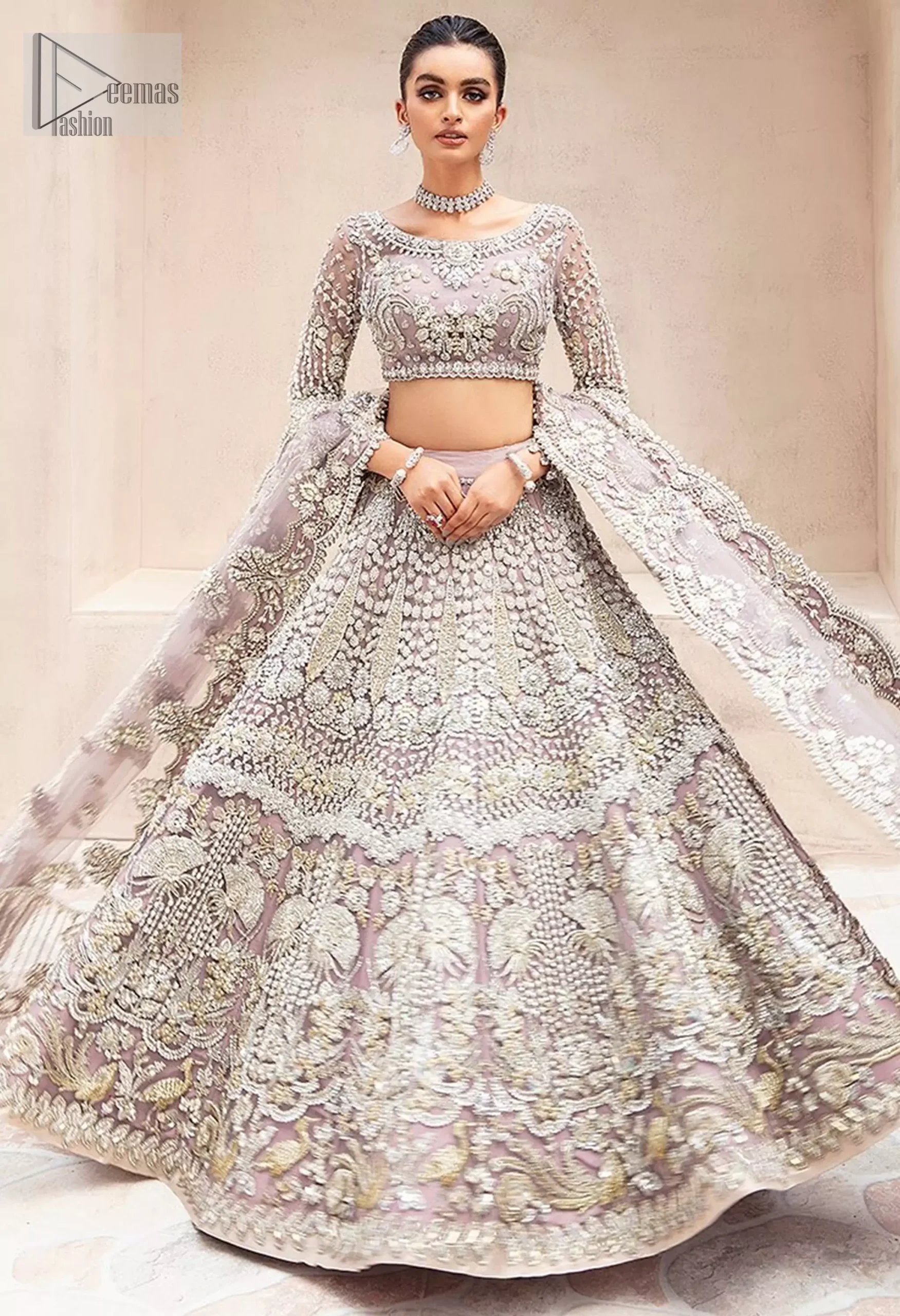 The chic short blouse, with its sophisticated boat neckline and sleeves, brings a modern touch, while the flowing lehenga embodies timeless grace. Pastel Pink Lehenga Short Blouse – Dupatta for Nikah Bride