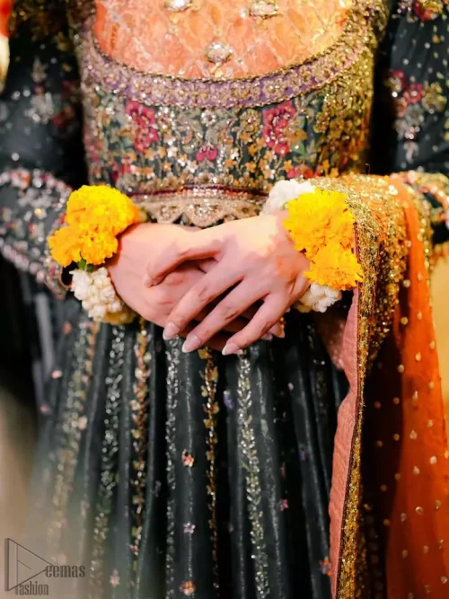 Close-up of the embellished bottle green bodice with golden and antique embroidery.