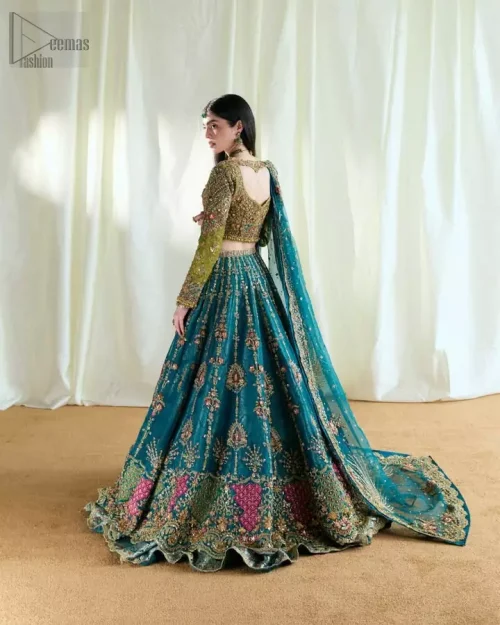 Rear view of olive blouse and teal double-layer lehenga showing architectural flair.