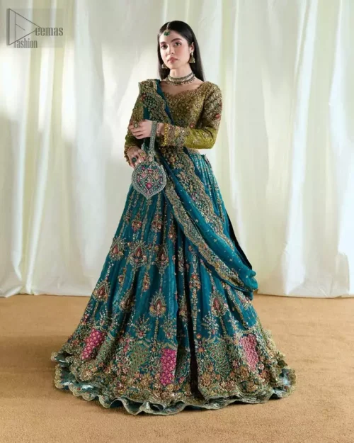 Angled movement shot of olive blouse and teal Rajistaani lehenga ensemble.
