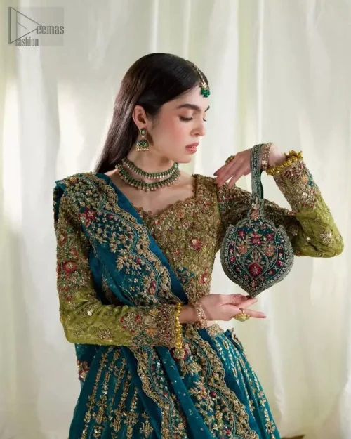 Upper tier of teal double-layer Rajistaani lehenga with heavy gold embroidery.