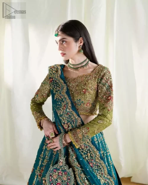 Teal pure katan organza dupatta with multicolour embroidery draped gracefully.