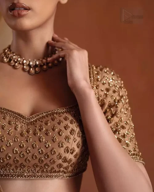 Fixed waist belt and side zipper construction on bronze lehenga.