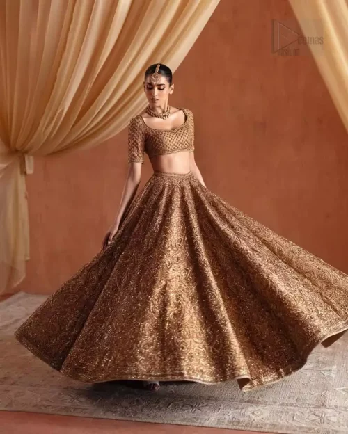 Half-sleeve construction and side zip closure on bronze bridal blouse.