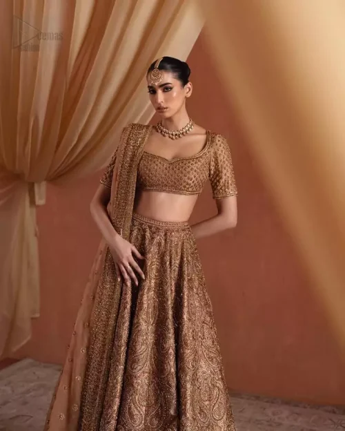 Sculptured embroidery and heavy border on bronze lehenga hemline.
