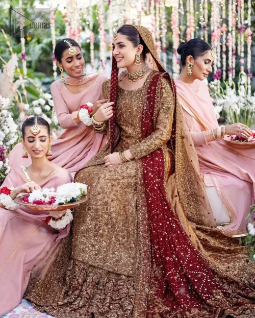 The copper long shirt is paired with a farshi-style lehenga and a maroon Organza dupatta to create a traditional look.
