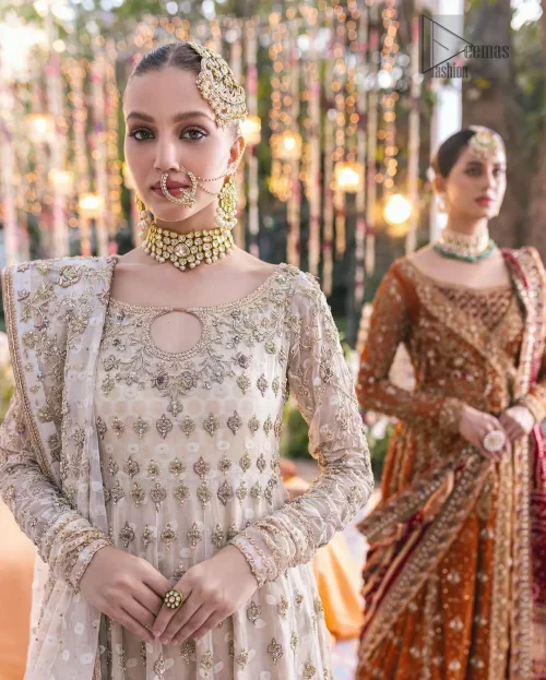 Close-up of round neckline and sculptured light golden embroidery on ivory pishwas bodice.