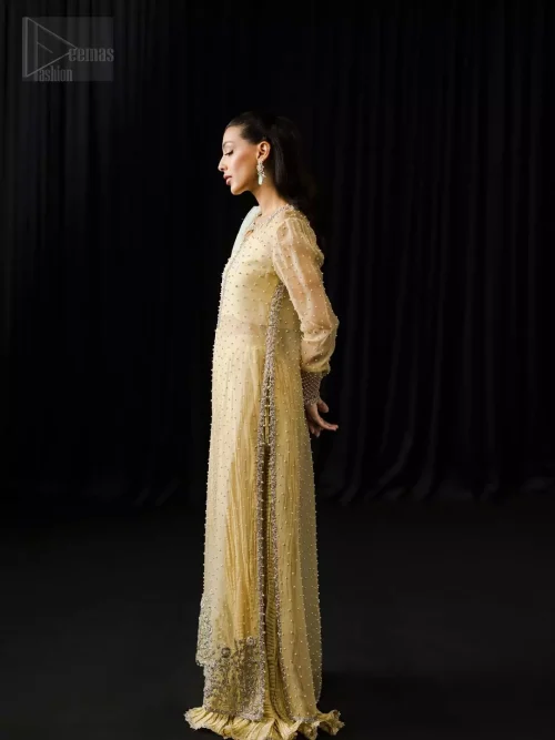 Embroidered side slits and concealed side zip on light yellow long shirt.