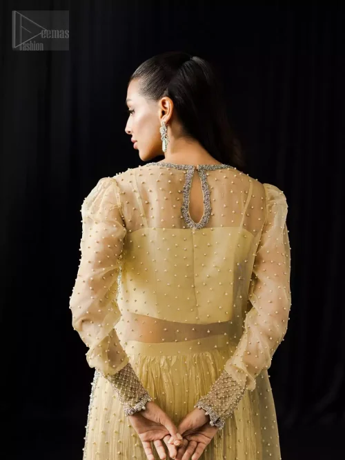 Rear perspective of light yellow side-open long shirt and crushed Dhaka pants.