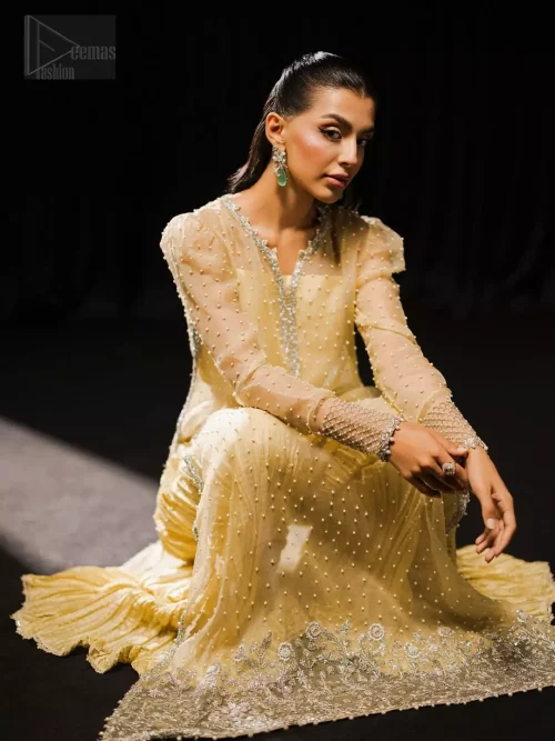 Three-quarter action view of light yellow long shirt, Dhaka pants, and ice blue dupatta in motion.