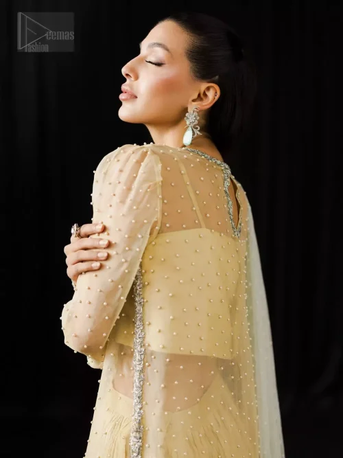 Tailored full sleeves and precise cuff construction on light yellow organza shirt.