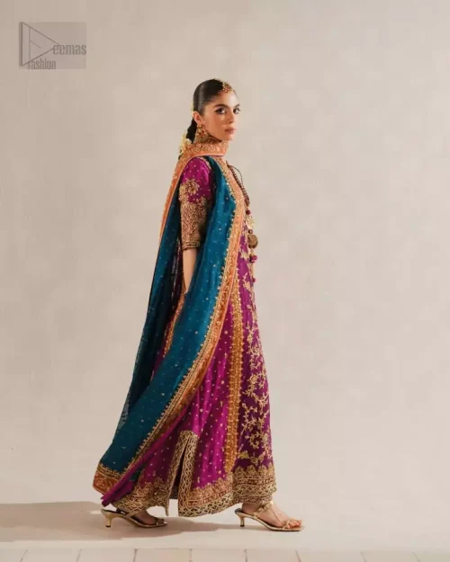 Three-quarter action shot of magenta long shirt palazzo set with teal blue dupatta.
