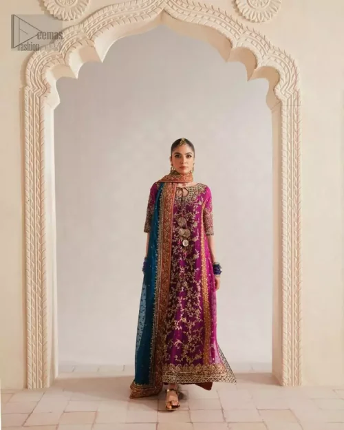 Modern magenta net long shirt with teal and rust appliqué paired with raw silk palazzos for mehndi.