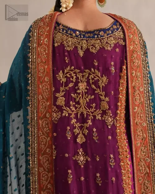 Rear architectural view of magenta long net shirt and sleek raw silk palazzo trousers.
