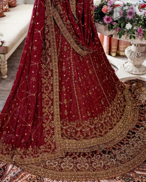The regal mustard lehenga flows beneath, adding contrast and depth to the silhouette.
