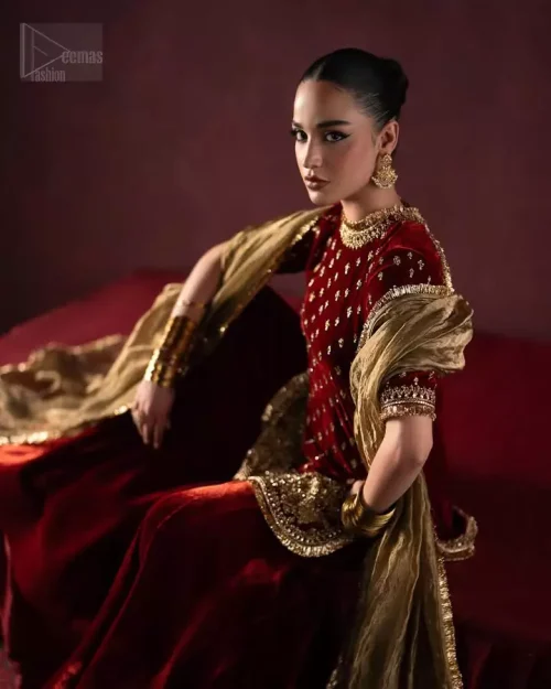 Angled action shot of maroon velvet short shirt and sharara in motion.