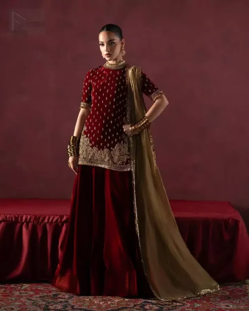 Maroon velvet short shirt and sharara with kiran lace for evening wedding parties.