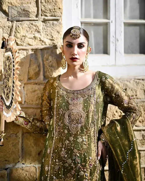 A sophisticated olive green formal dress combining a long embroidered shirt and palazzos, made from fine banarsi jamawar and pure