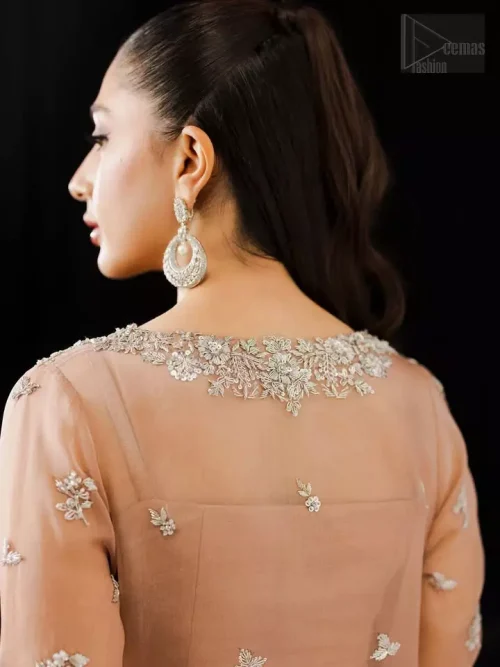 Rear view of pale peach floor-length organza shirt and cigarette pants ensemble.