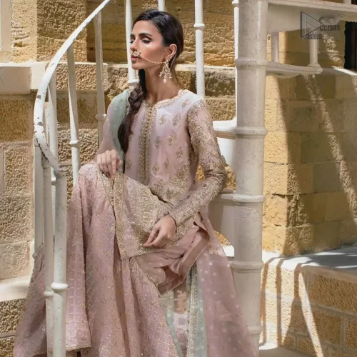 Tailored full sleeves and pure raw silk fabric texture on pastel pink shirt.