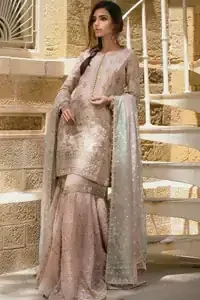 Wide flare and embroidered hemline of pastel pink katan organza gharara.