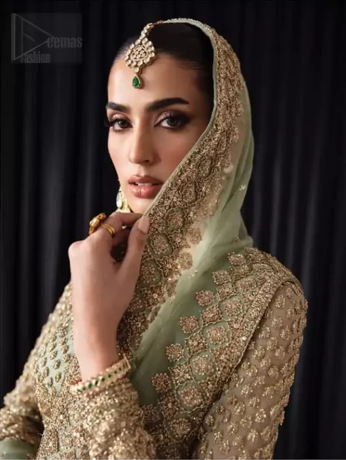 Jewel neckline and heavy golden embroidery on pistachio organza shirt bodice.