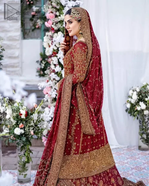 Rear view of red organza long shirt and sweeping banarsi farshi lehenga train.