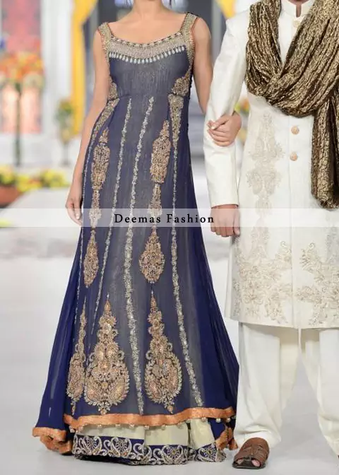 Navy blue pure chiffon sides down back trail frock with off white inner layer or lehenga. Frock has been adorned with embroidered neckline and motifs on both sides. Center panel has been embellished with large motifs and small borders. Embroidered lace implemented at the bottom of lehenga.